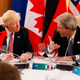 President Donald Trump listens to Italian Prime Minister Paolo Gentiloni as they sit around a table during the G7 Summit in Italy on May 26, 2017 (Jonathan Ernst/Pool Photo via AP) with an arrow added by Gizmodo just in case you didn’t get the point
